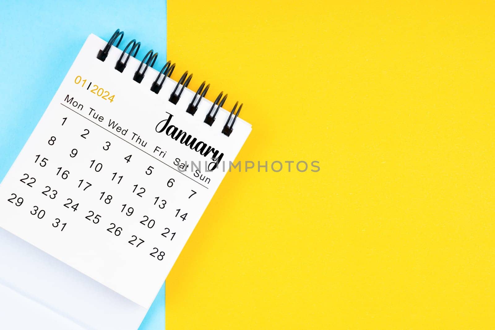 January 2024, Monthly desk calendar for 2024 year on yellow and blue color background.