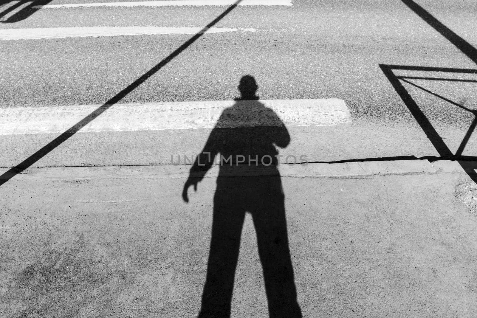 Shadowy Figure Strolling Down an Urban Street. Black and white photo by darksoul72