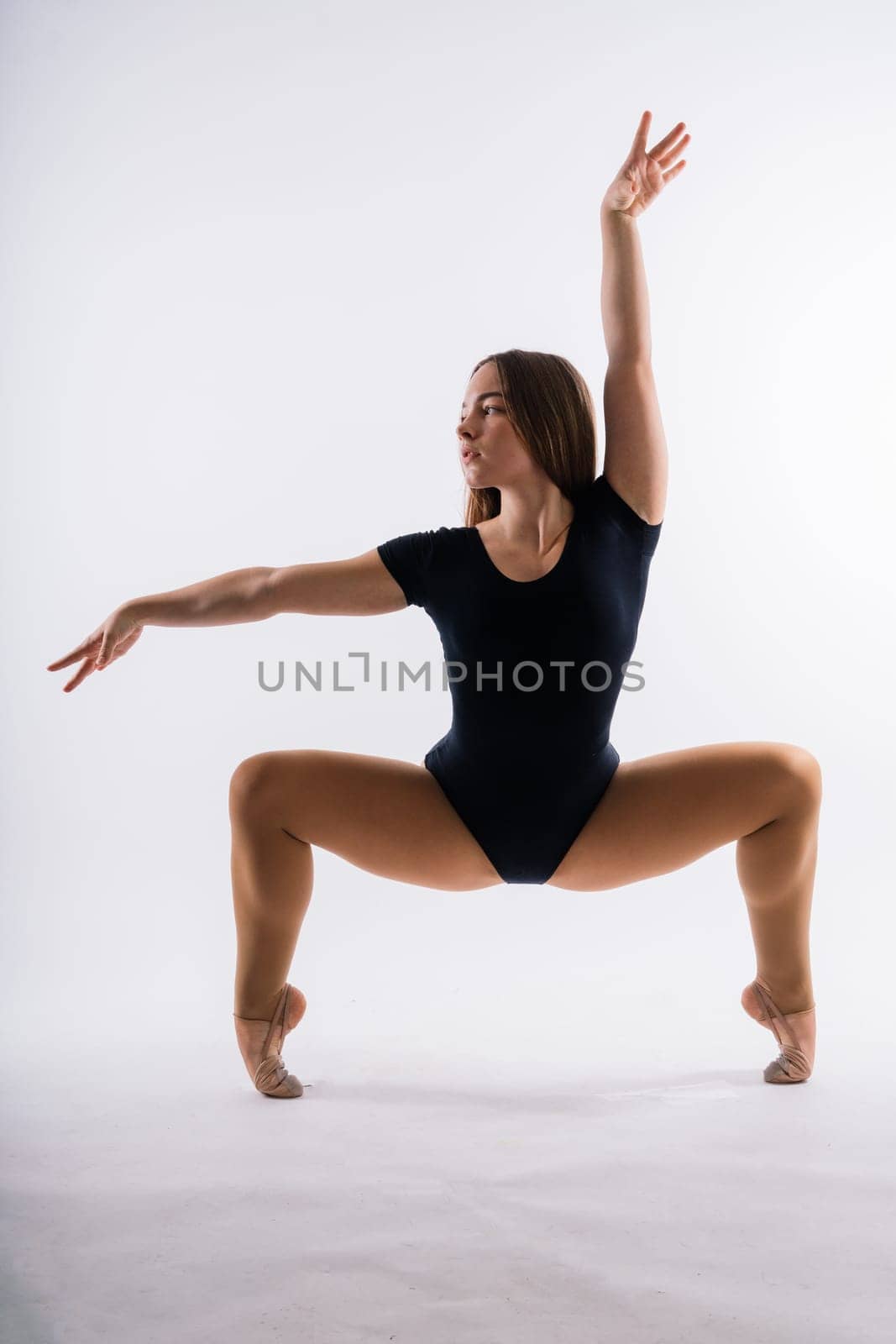 Gymnastics, woman acrobat, female gymnast strong flexible body over black and white backgrounds