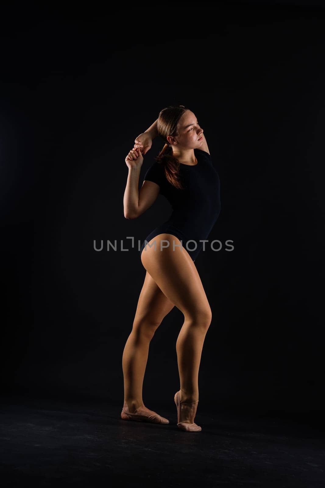 Gymnastics, woman acrobat, female gymnast strong flexible body over black and white backgrounds