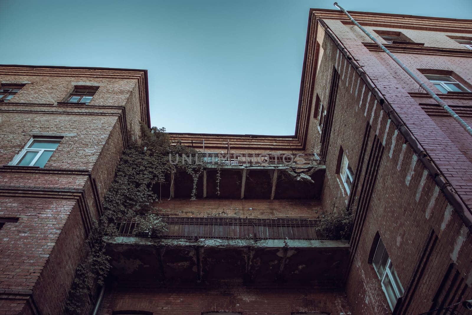 Old damaged architecture in Kharkiv in spring. Cityscape photo in Ukraine. Urban city life during the war. High quality picture for wallpaper, travel blog.