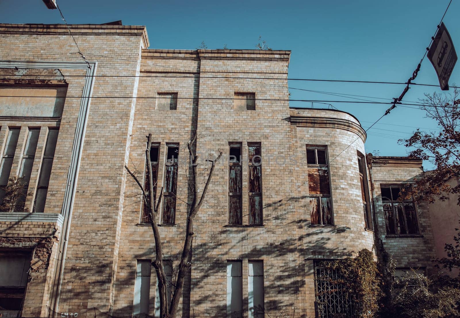 Front view of abandoned old building concept photo. Ruined walls and windows. Old brick destroyed building photography. Street scene. High quality picture for wallpaper, travel blog.