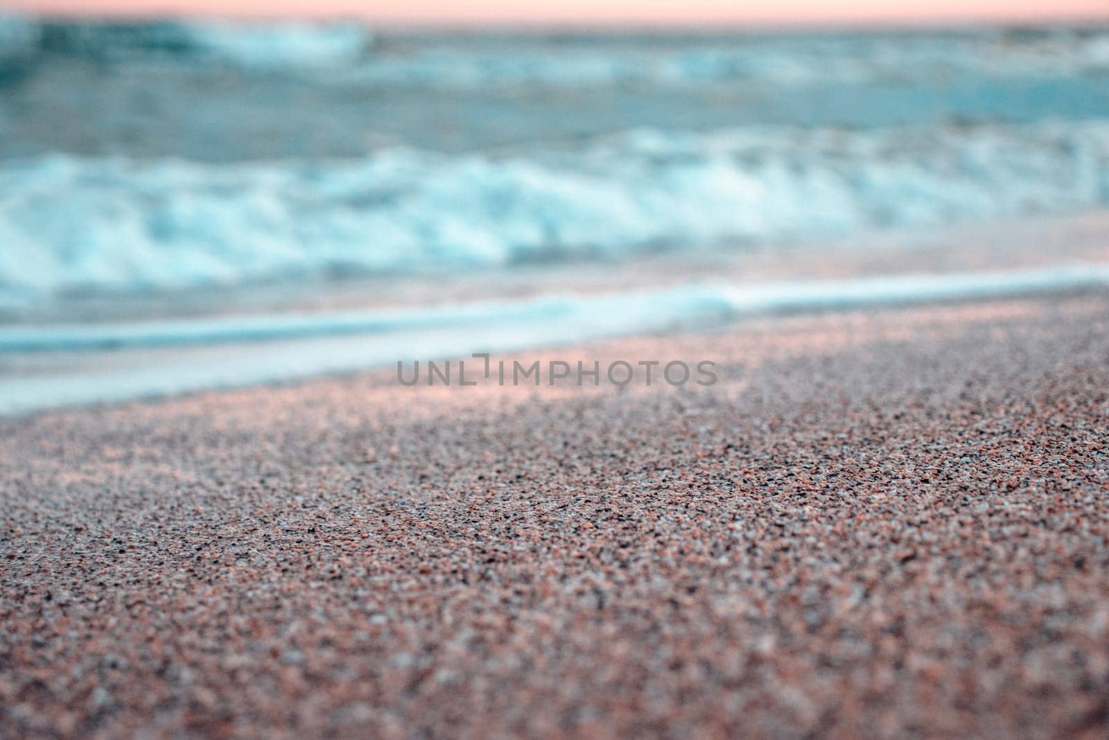 Close up sand beach and ocean waves concept photo. Barcelona resort, blue sea. Front view photography with blurred background. High quality picture for wallpaper