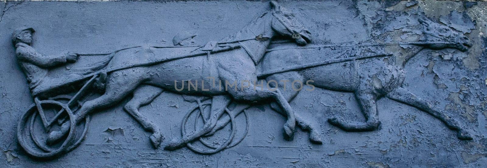 Close up metal bas-relief with jockey and horses concept photo. by _Nataly_Nati_