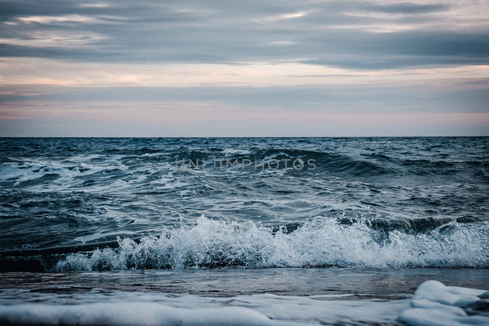 Stormy Mediterranean sea water landscape photo. Beautiful nature scenery photography with evening on background. Idyllic scene. High quality picture for wallpaper, travel blog