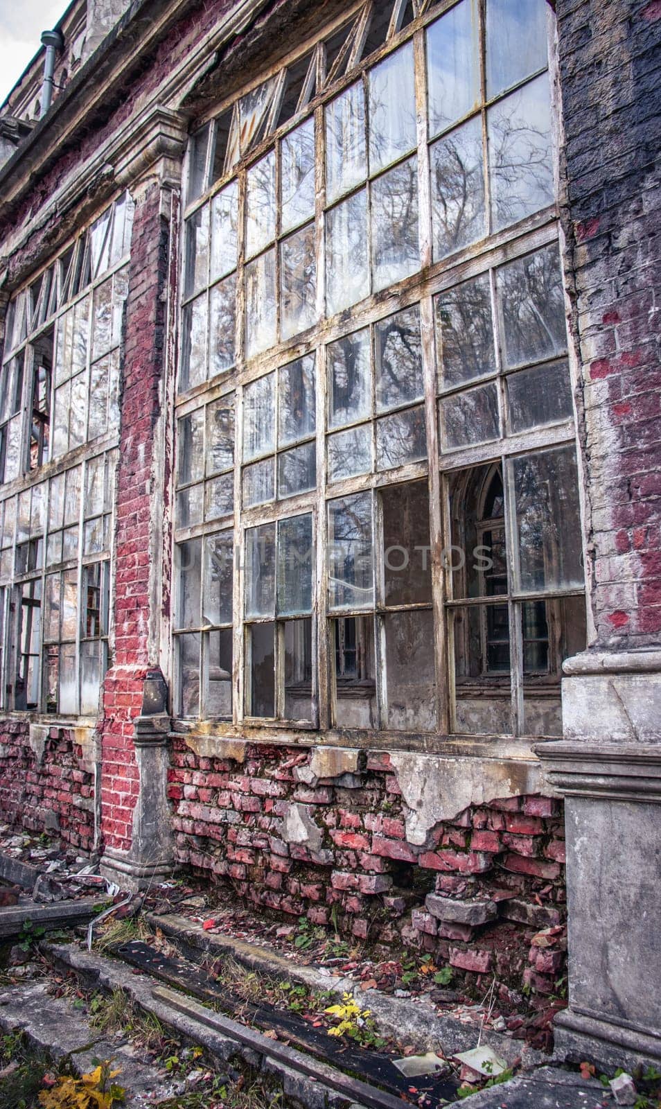 Old building with damaged windows concept photo. European towers. Architectural detail of ruined castle. Old doors, windows, balconies. Ukrainian moldings