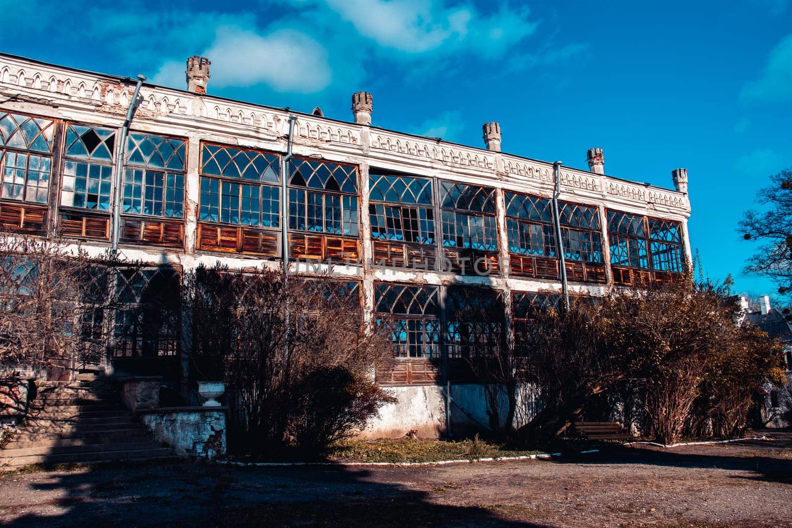 Summer terrace of the old palace concept photo. Vintage ruined building in neo-gothic style. Sugar Palace in Kharkov region, Ukraine. A beautiful historical building in a European city.