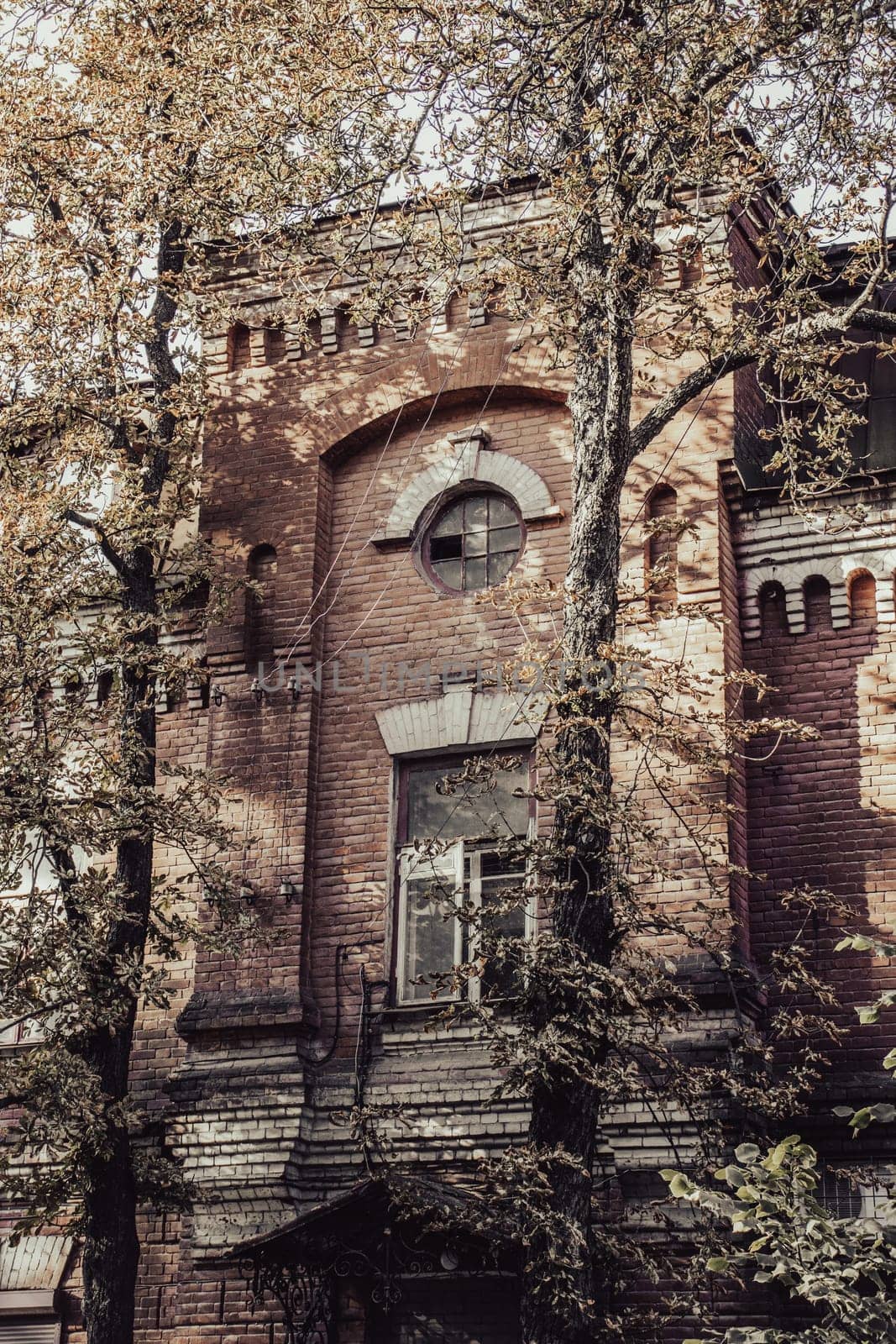 Old vintage brick building in autumn cityscape concept photo by _Nataly_Nati_