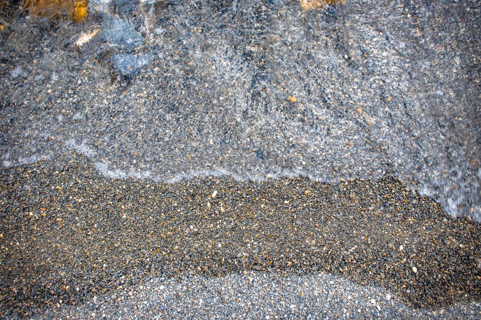 Close up water with stones background concept photo. Pebbles under water. The view from the top, nautical background. High quality picture for wallpaper