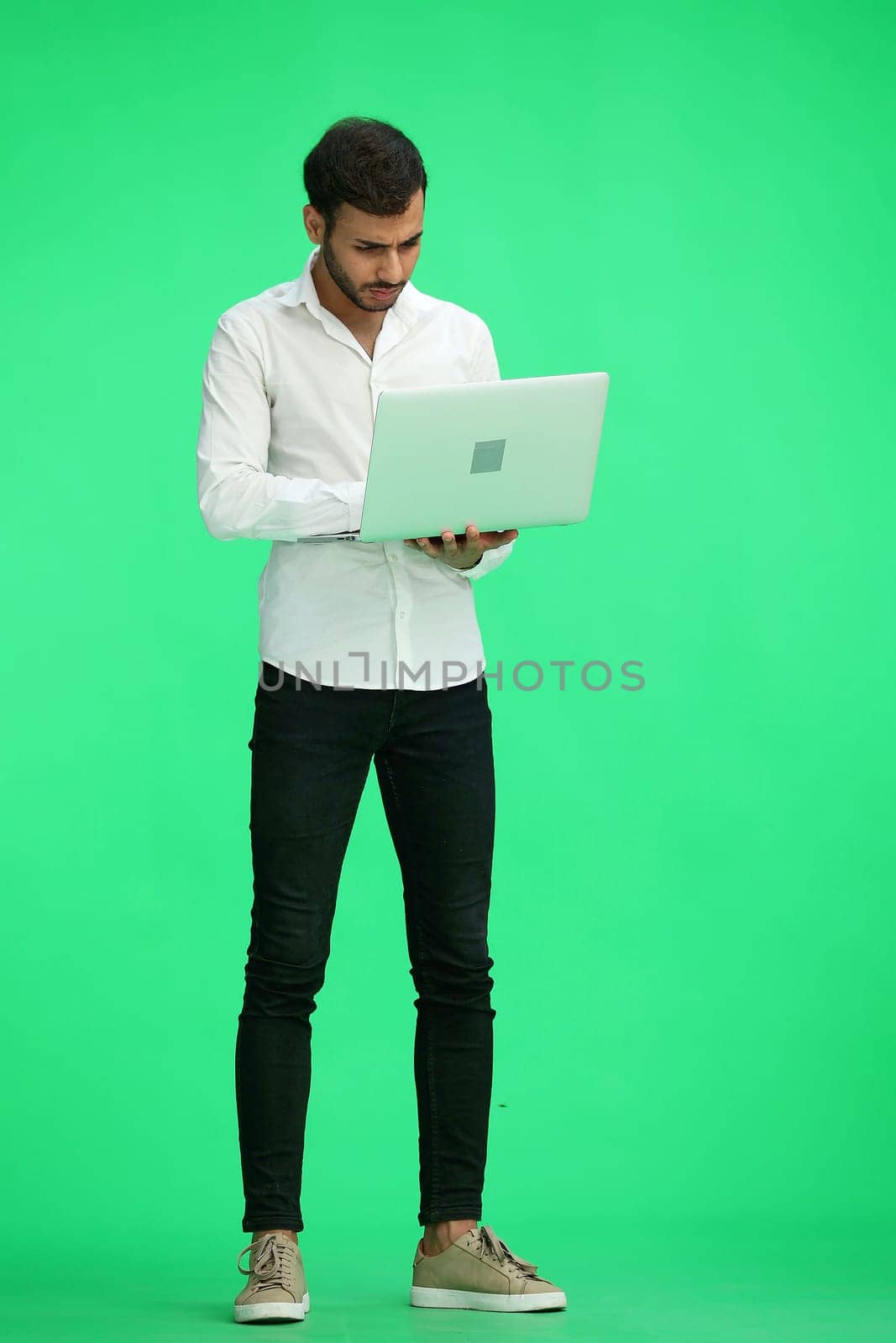 man on a green background. uses a computer by Prosto