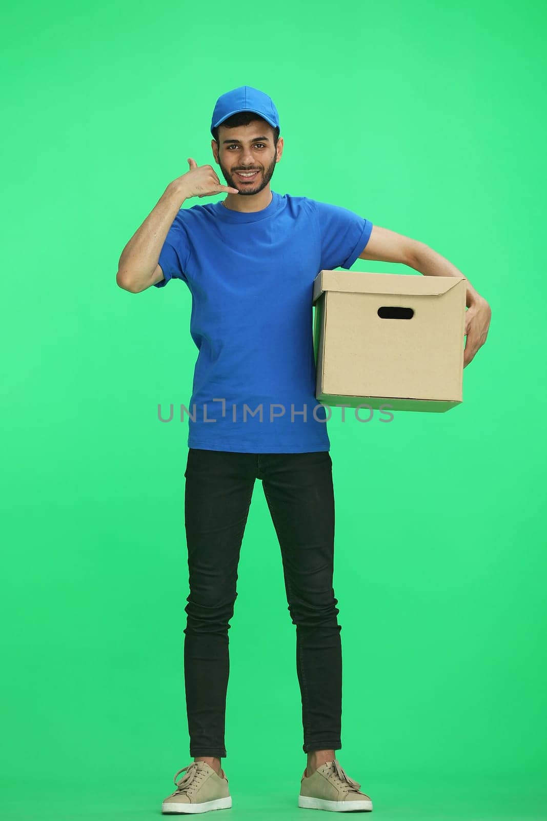 A man on a green background with box show a call.