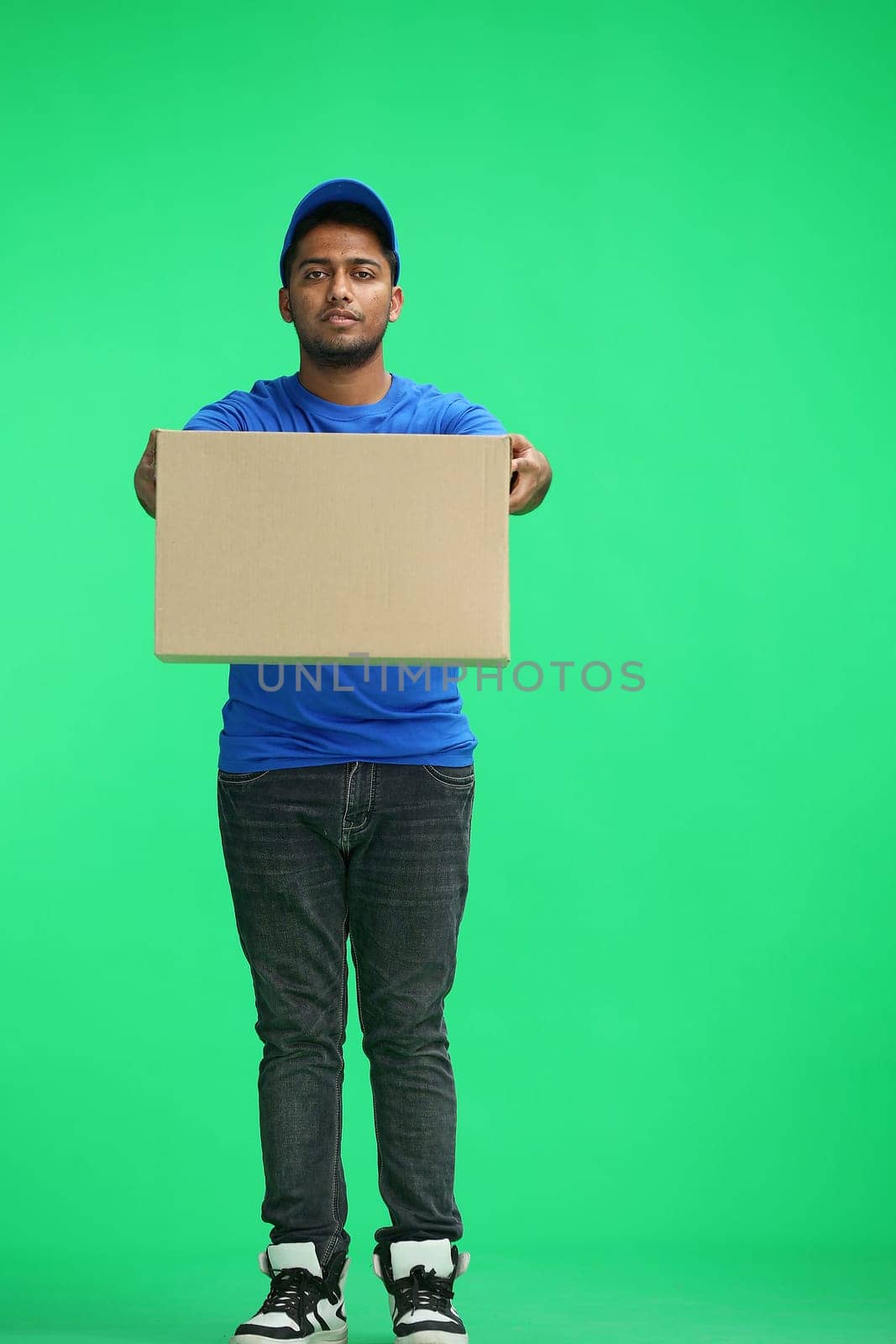 A man on a green background give box.