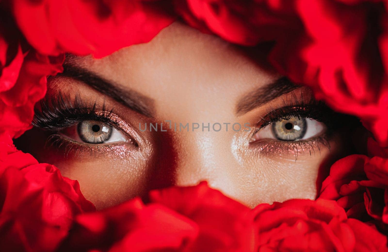 Macro woman eyes with vibrant make-up in roses flowers.Skin care, beauty concept by kristina_kokhanova