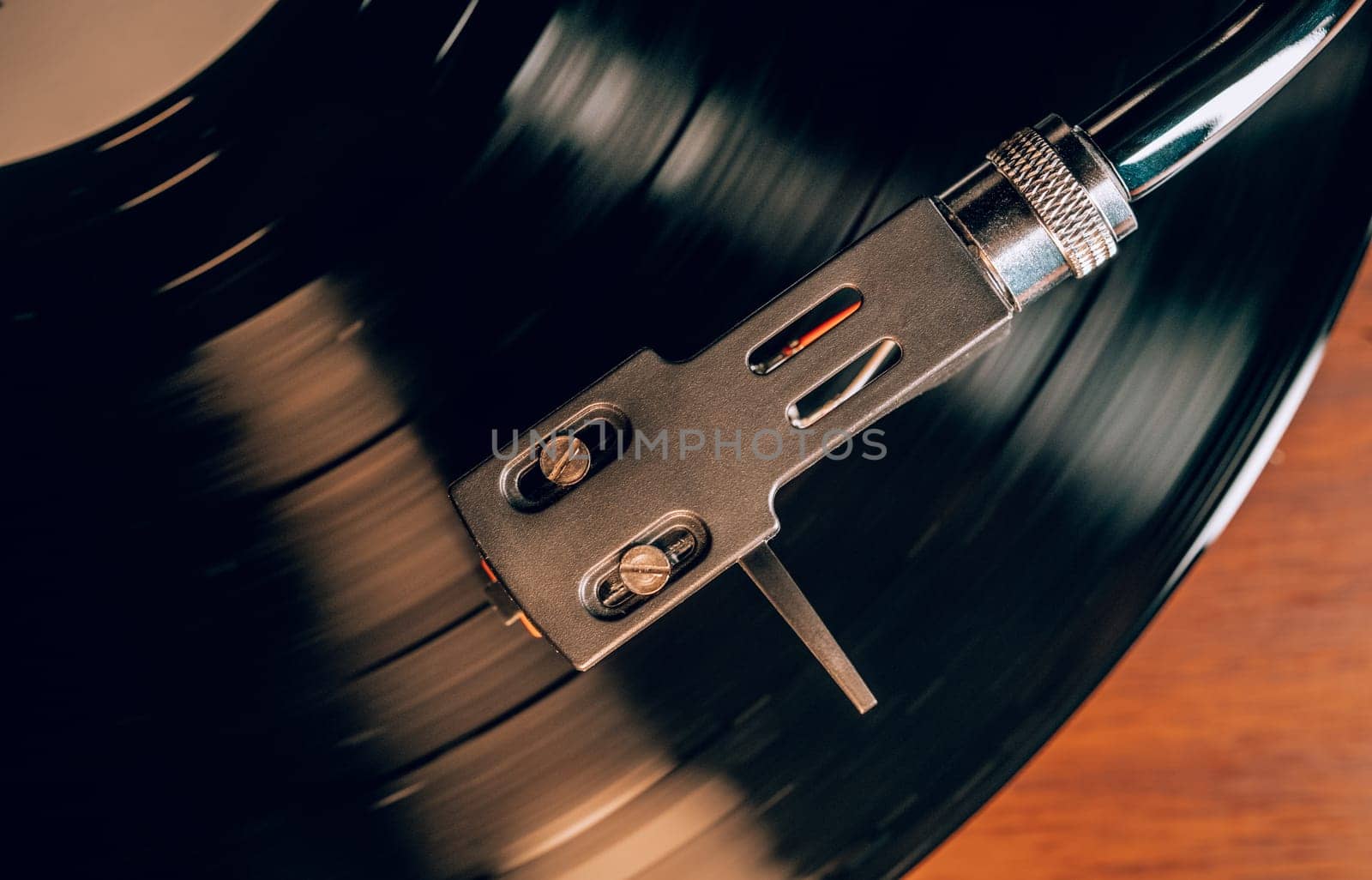 Classic stylus needle traces grooves of vinyl record. Music nostalgia. Retro vibes, vintage aesthetics, analog sound. High quality