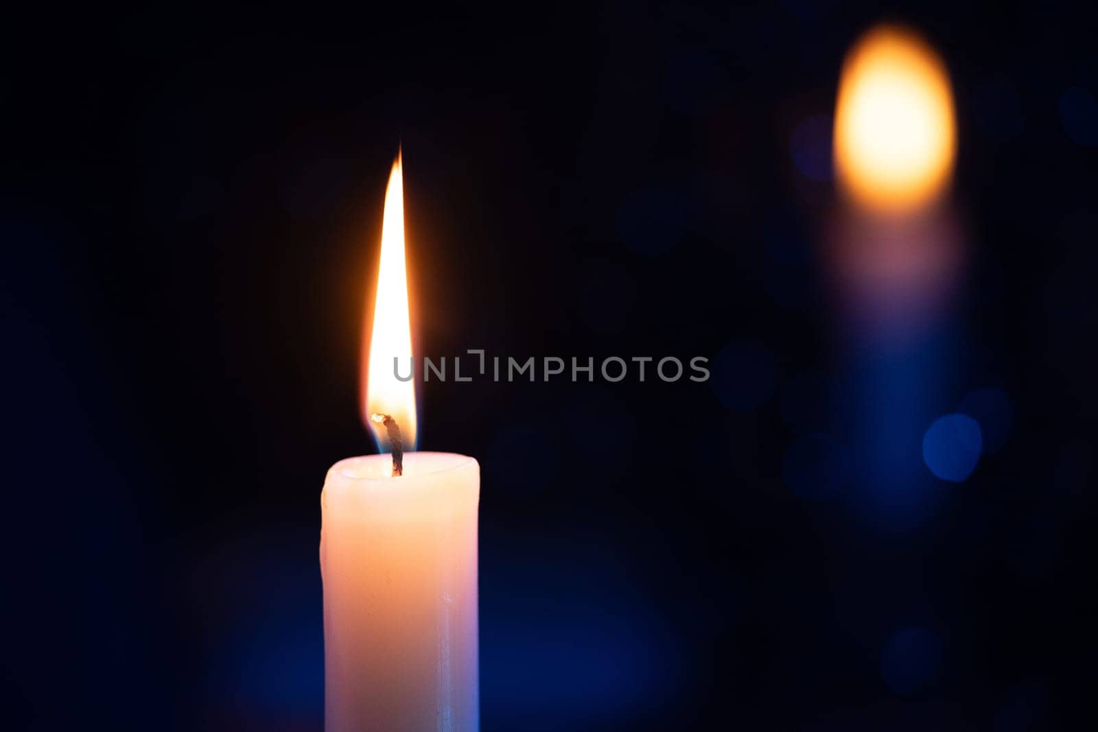 Candle background. Rainy night window, reflection of fire flame. Cozy ambience of fall, candle burning. Tranquil visual storytelling. Rainy autumn weather.