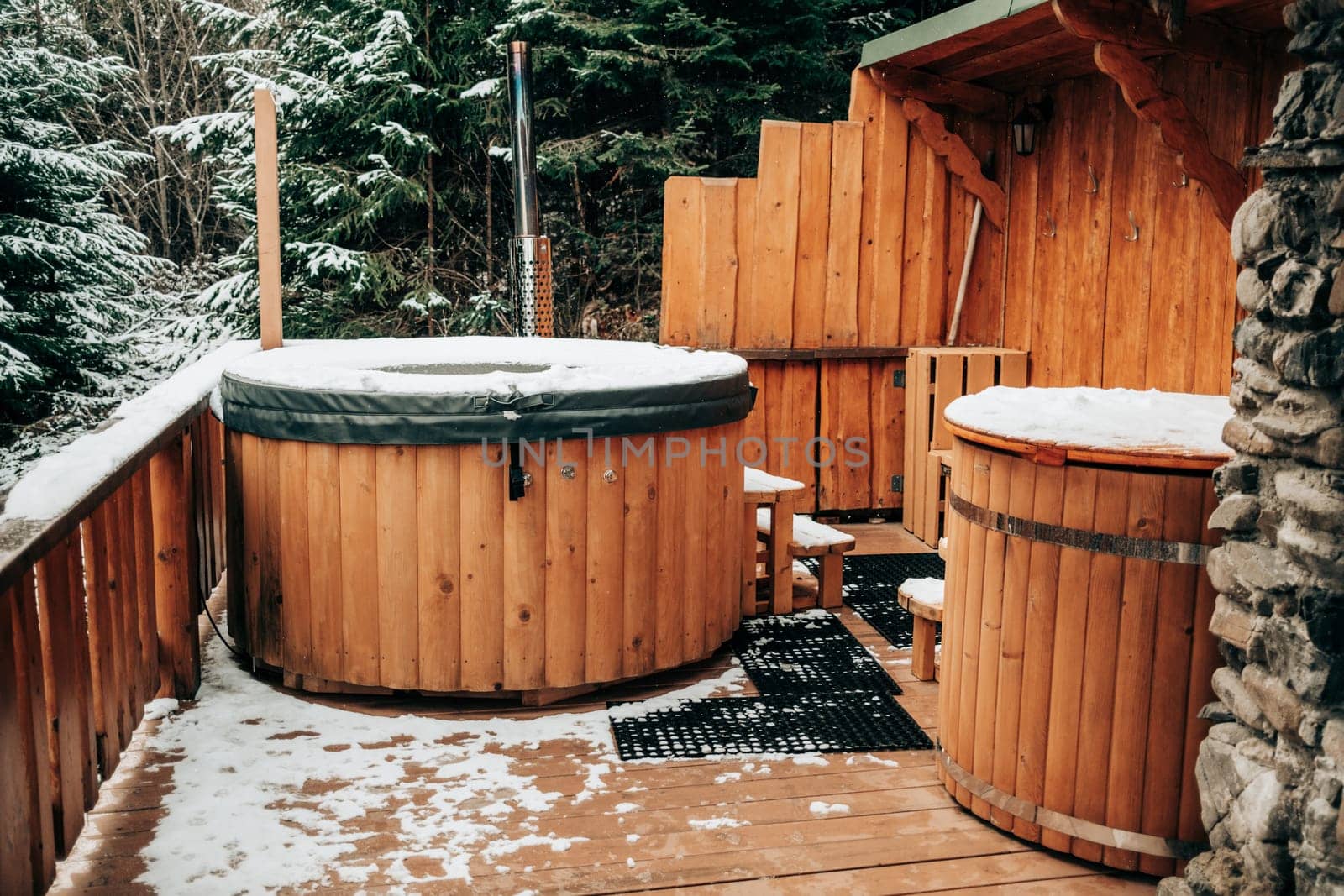 Open-air bath interior near forest, winter, snow view. Wooden hot tub outside by kristina_kokhanova