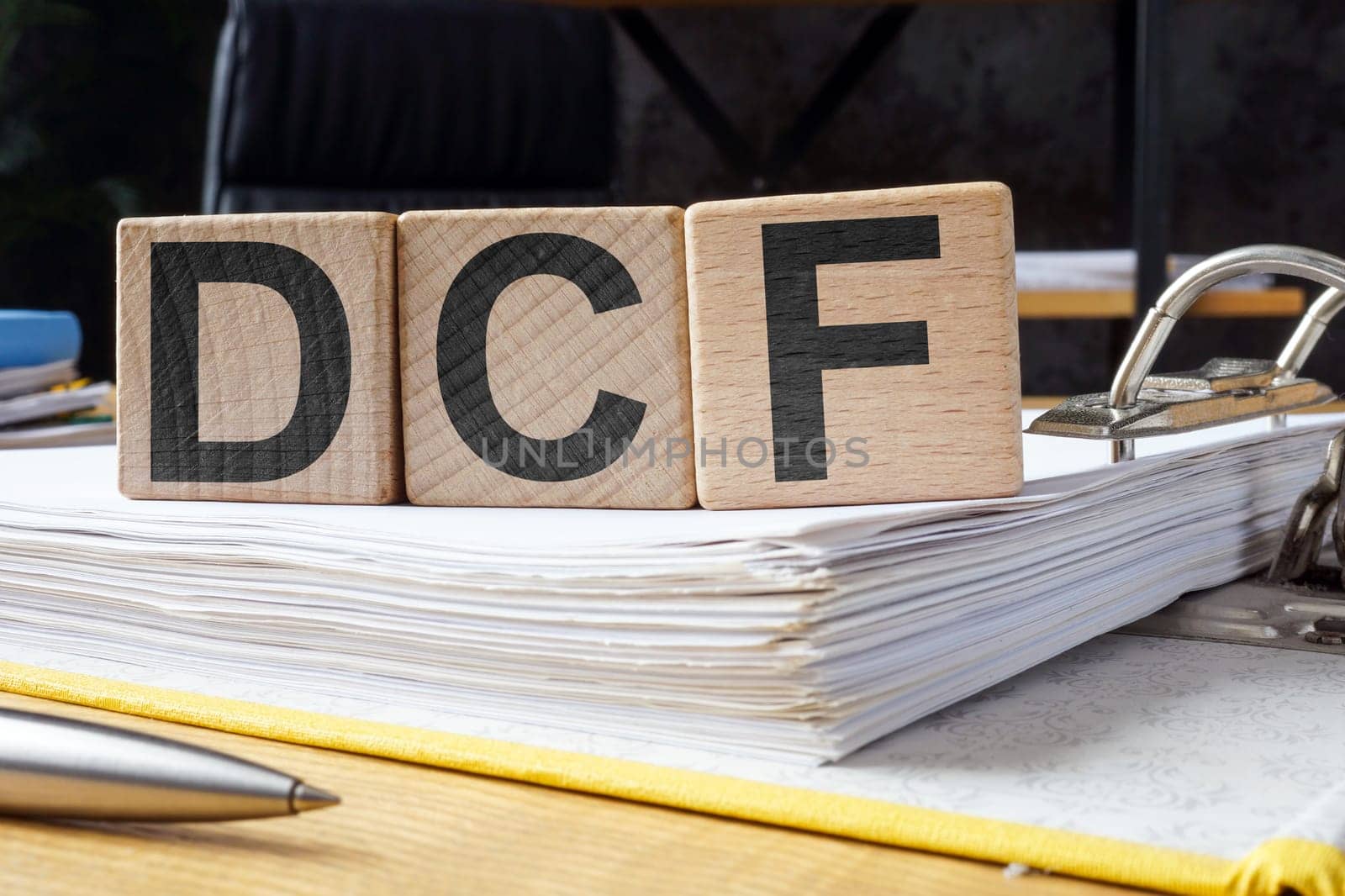 Open folder and cubes with letters DCF Discounted Cash Flow.