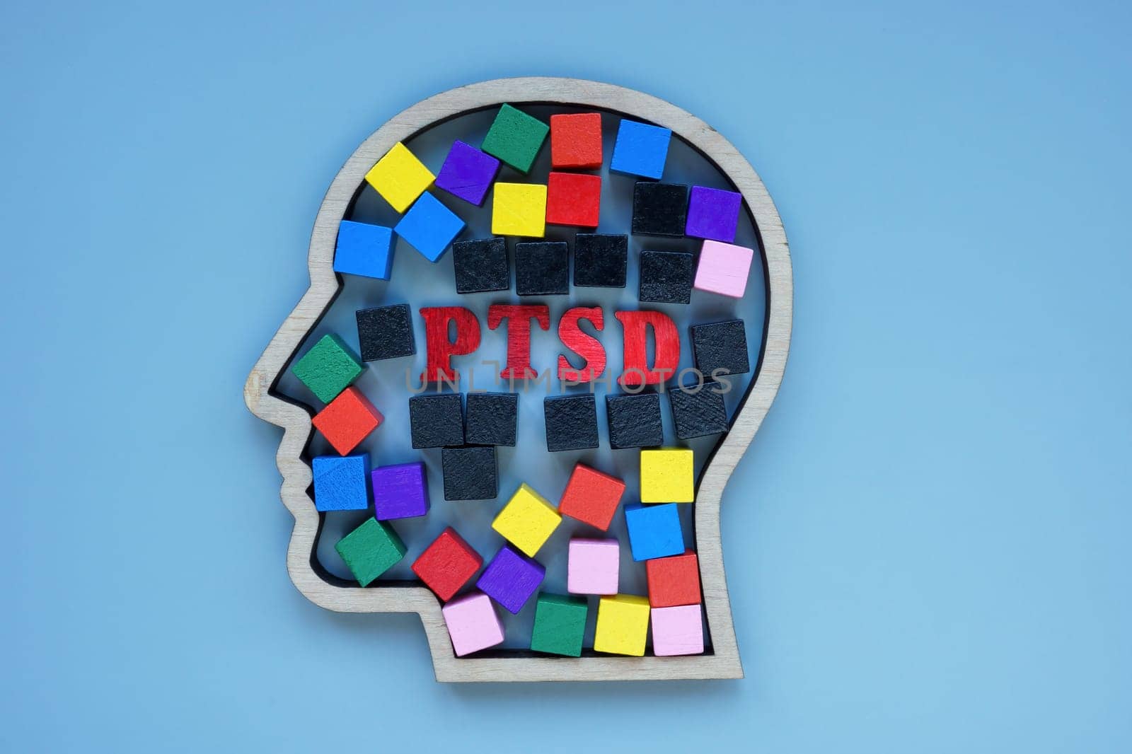 Head outline with colored cubes and inscription PTSD Post Traumatic Stress Disorder. by designer491