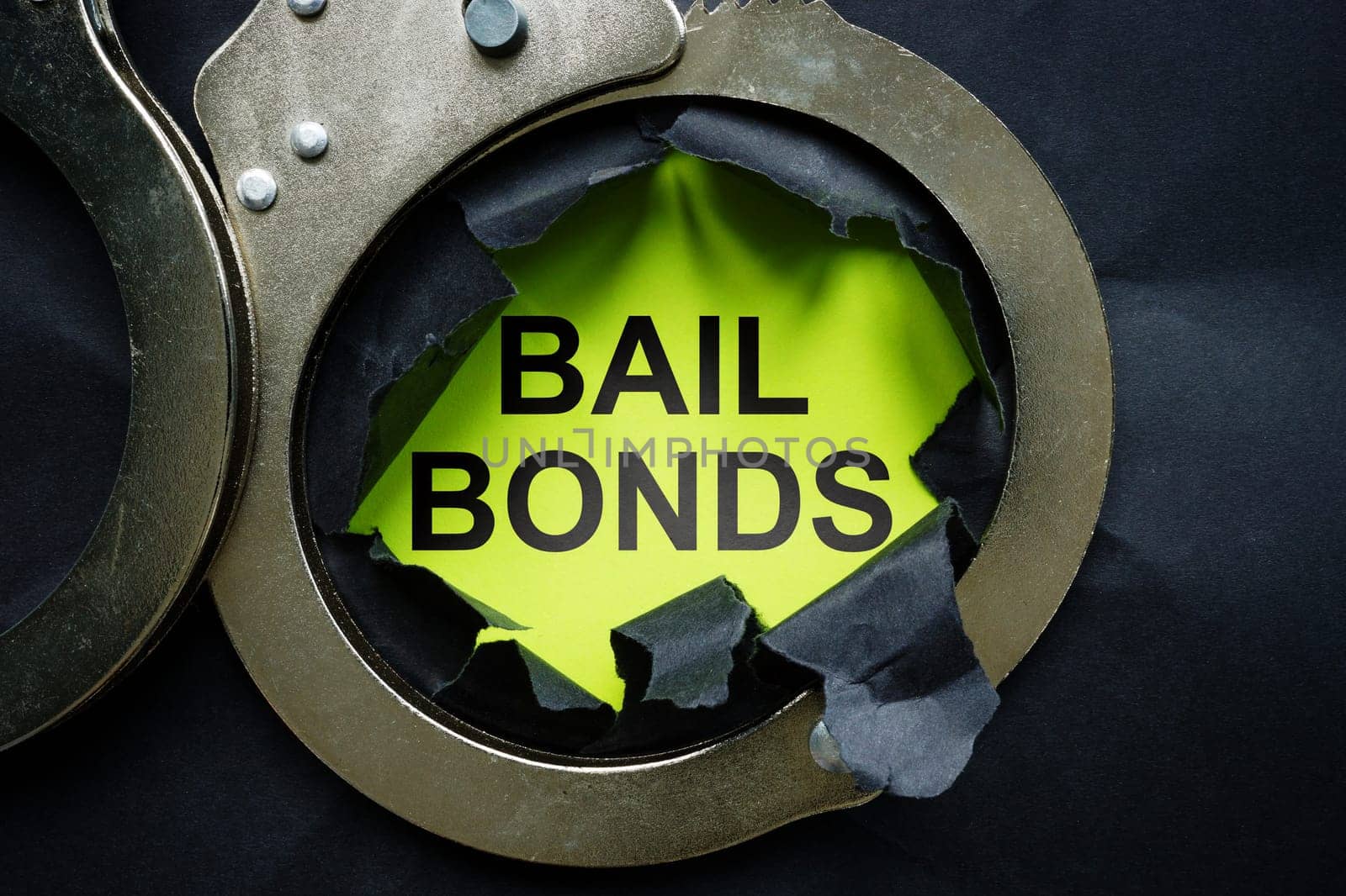 Bail bonds inscription and metal handcuffs.