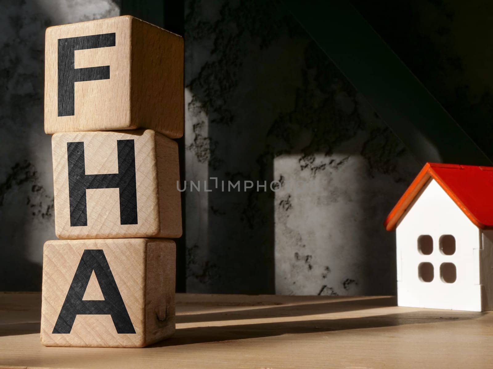Model of a house and letters FHA Federal Housing Administration.