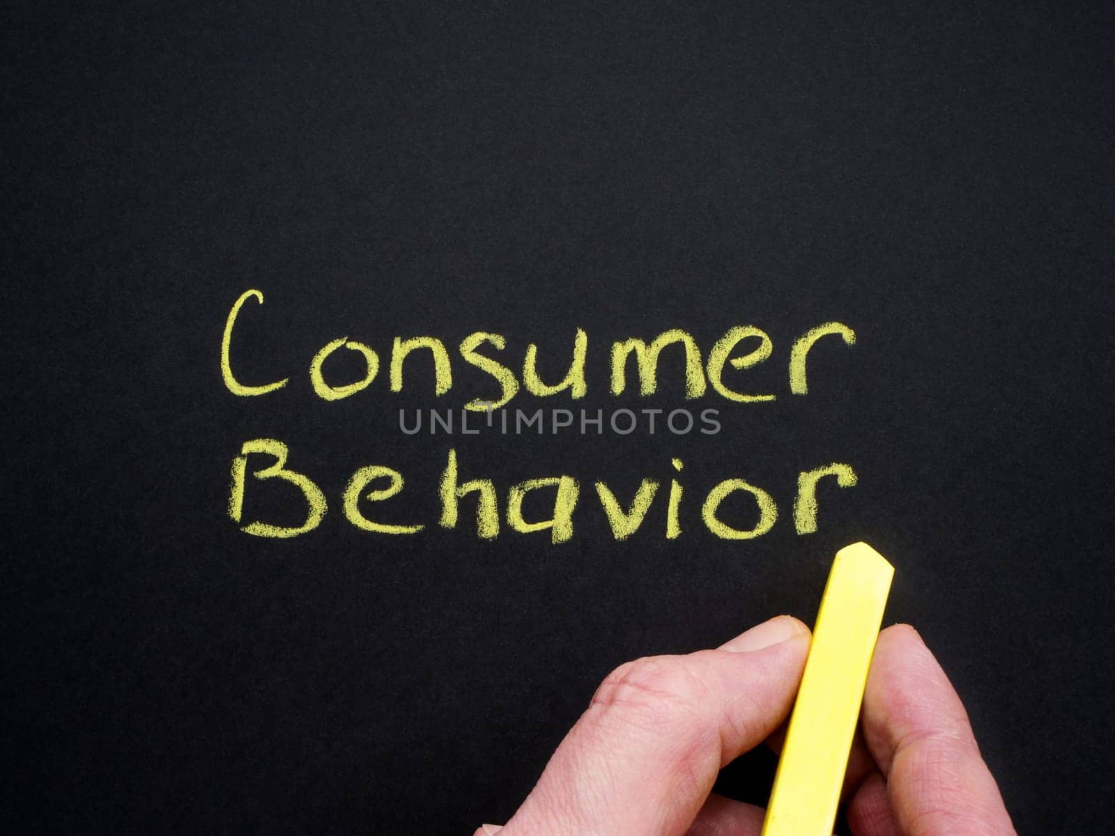 Consumer behavior inscription and hand with chalk. by designer491