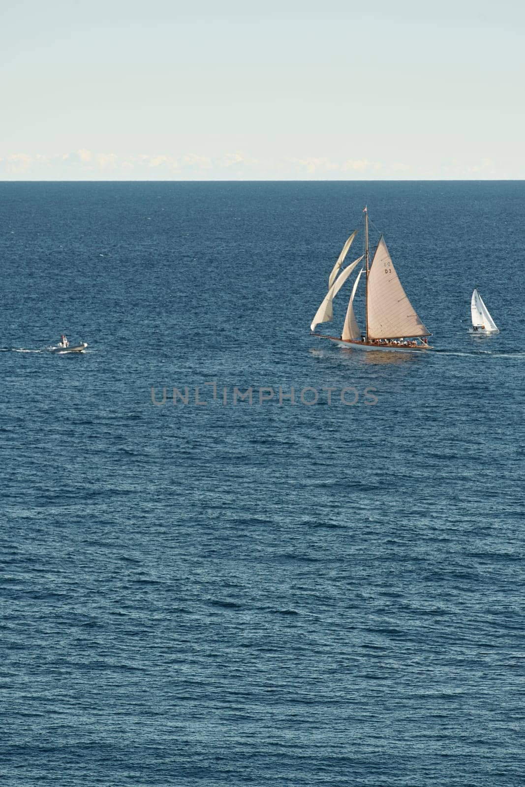 Monaco, lonely vintage sail yacht in sea at sunset, huge sail boat, wealth life of billionaires . High quality photo