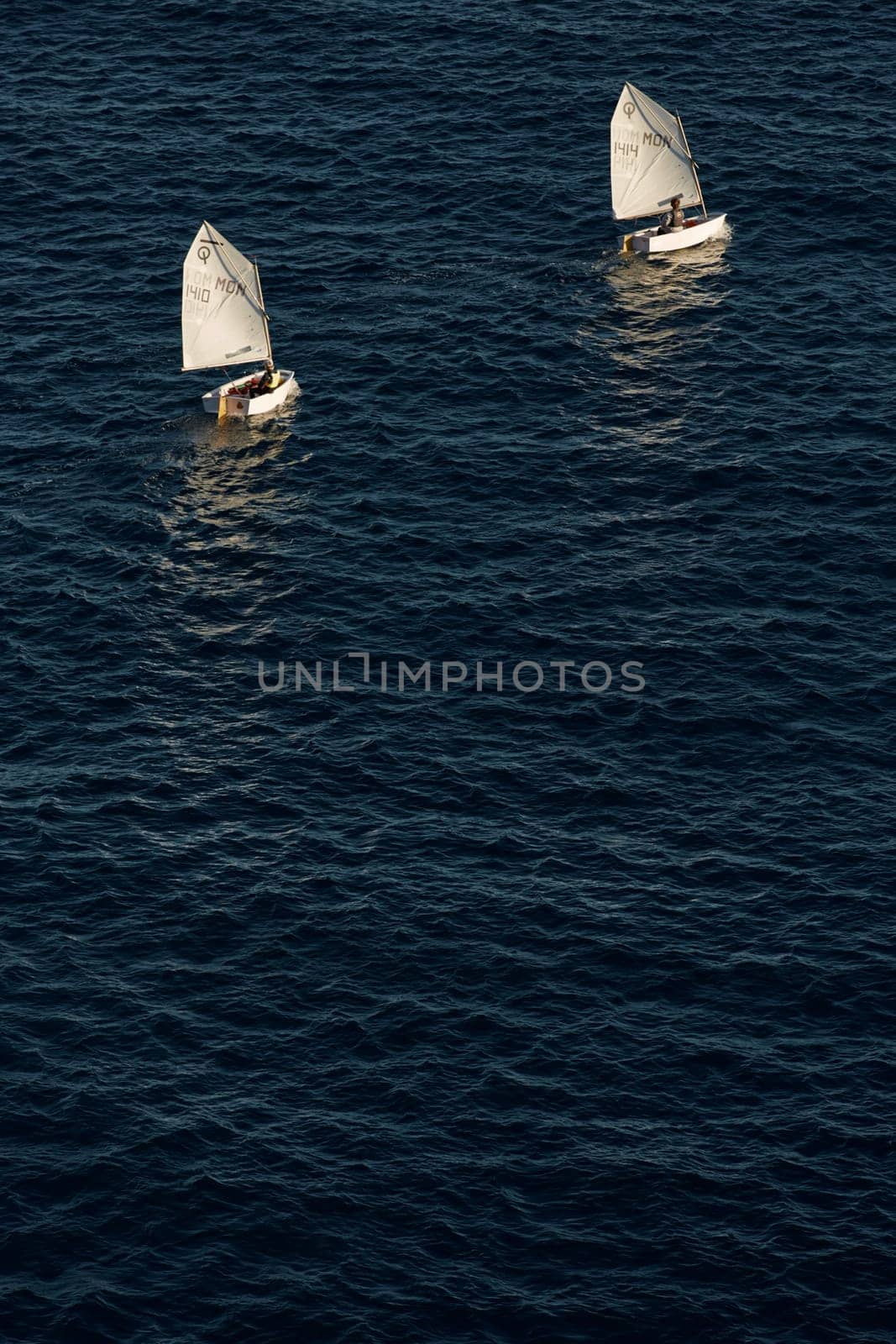 Monaco, Monte Carlo, 05 November 2022 - Two small sailing boats in sea at sunset, mediterranean lifestyle. High quality photo