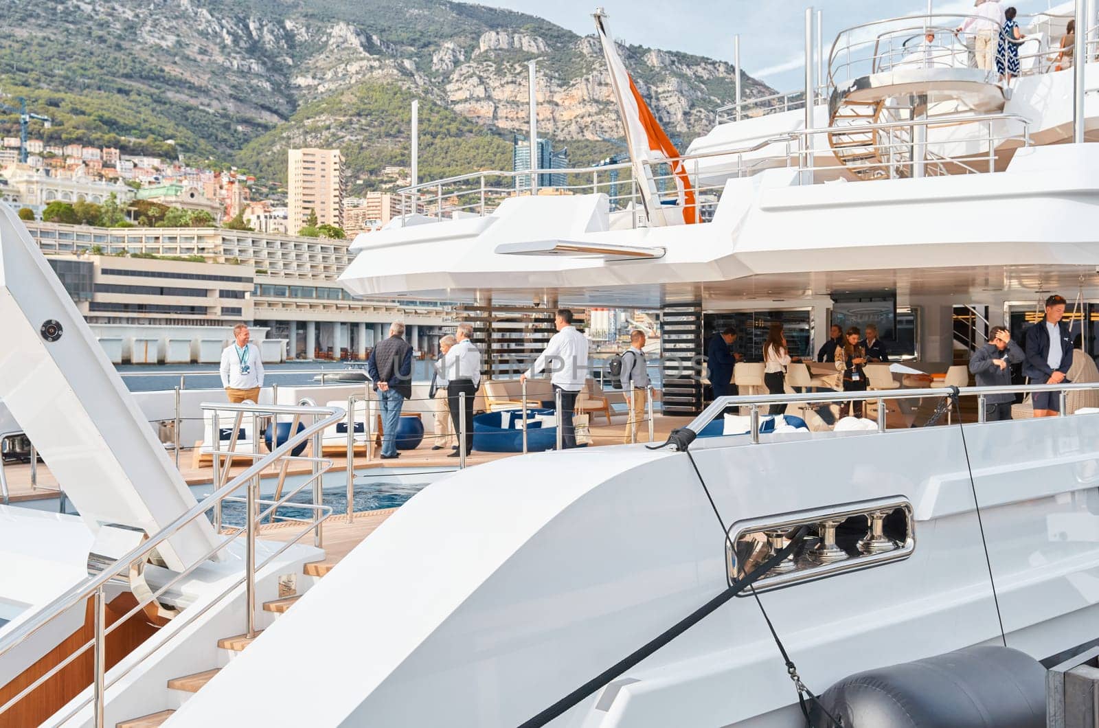 Monaco, Monte Carlo, 29 September 2022 - Invited wealthy clients inspect mega yachts at the largest fair exhibition in the world yacht show MYS, port Hercules, yacht brokers, sunny weather by vladimirdrozdin