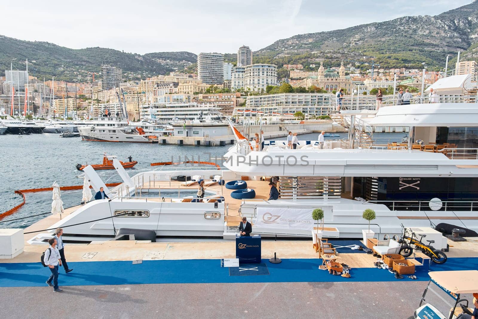 Monaco, Monte Carlo, 29 September 2022 - Invited wealthy clients inspect mega yachts at the largest fair exhibition in the world yacht show MYS, port Hercules, yacht brokers, sunny weather by vladimirdrozdin