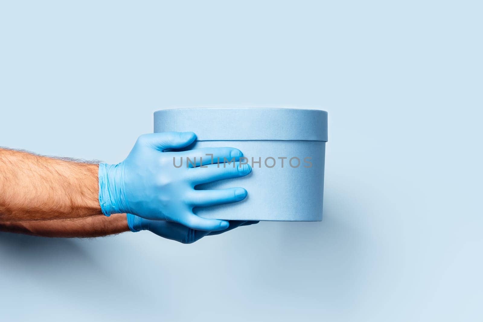 A blue background with hands holding a box. by AlexAbramova