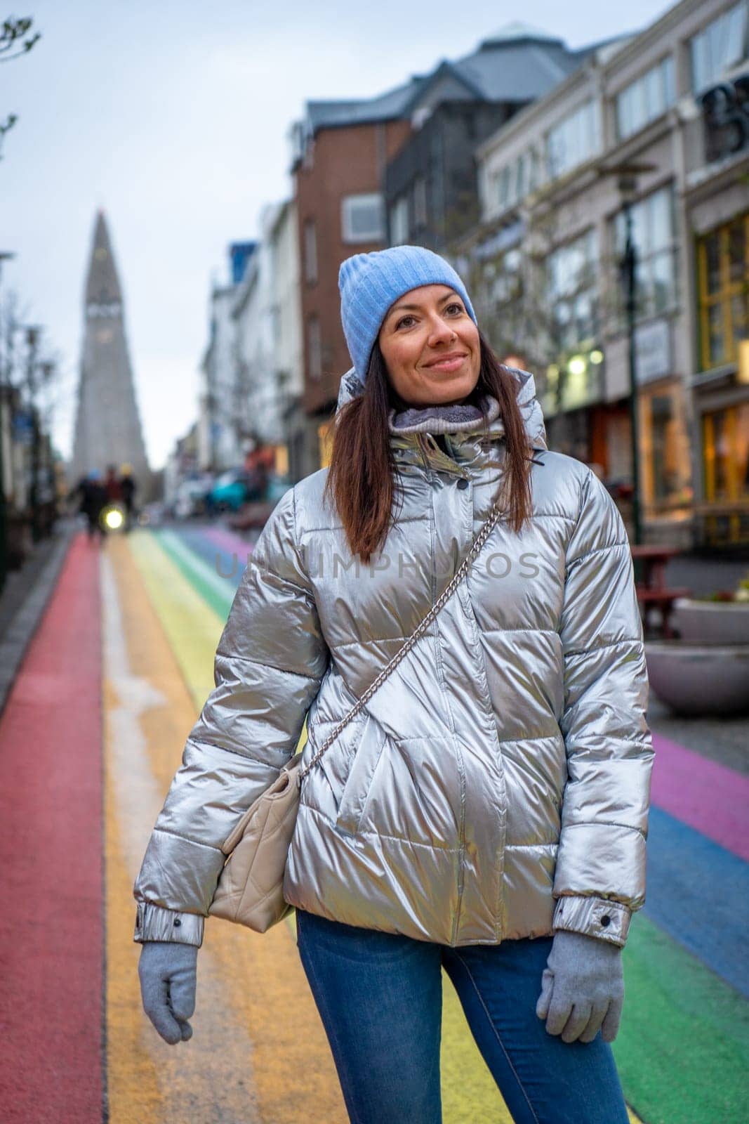 Woman with metallic jacket on Rainbow street in Reykjavik, Iceland by LopezPastor