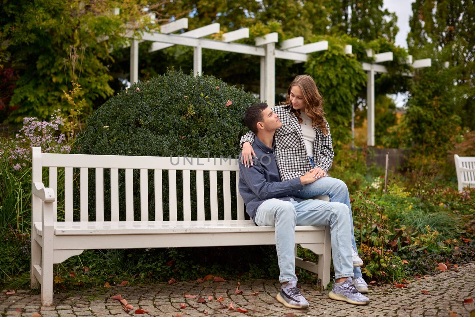 Young Cute Female Hugs Boyfriend. In Autumn Outdoor. Lovers Walking in Park. Attractive Funny Couple. Lovestory in Forest. Man and Woman. Cute Lovers in the Park. Family Concept. Happy Couple.