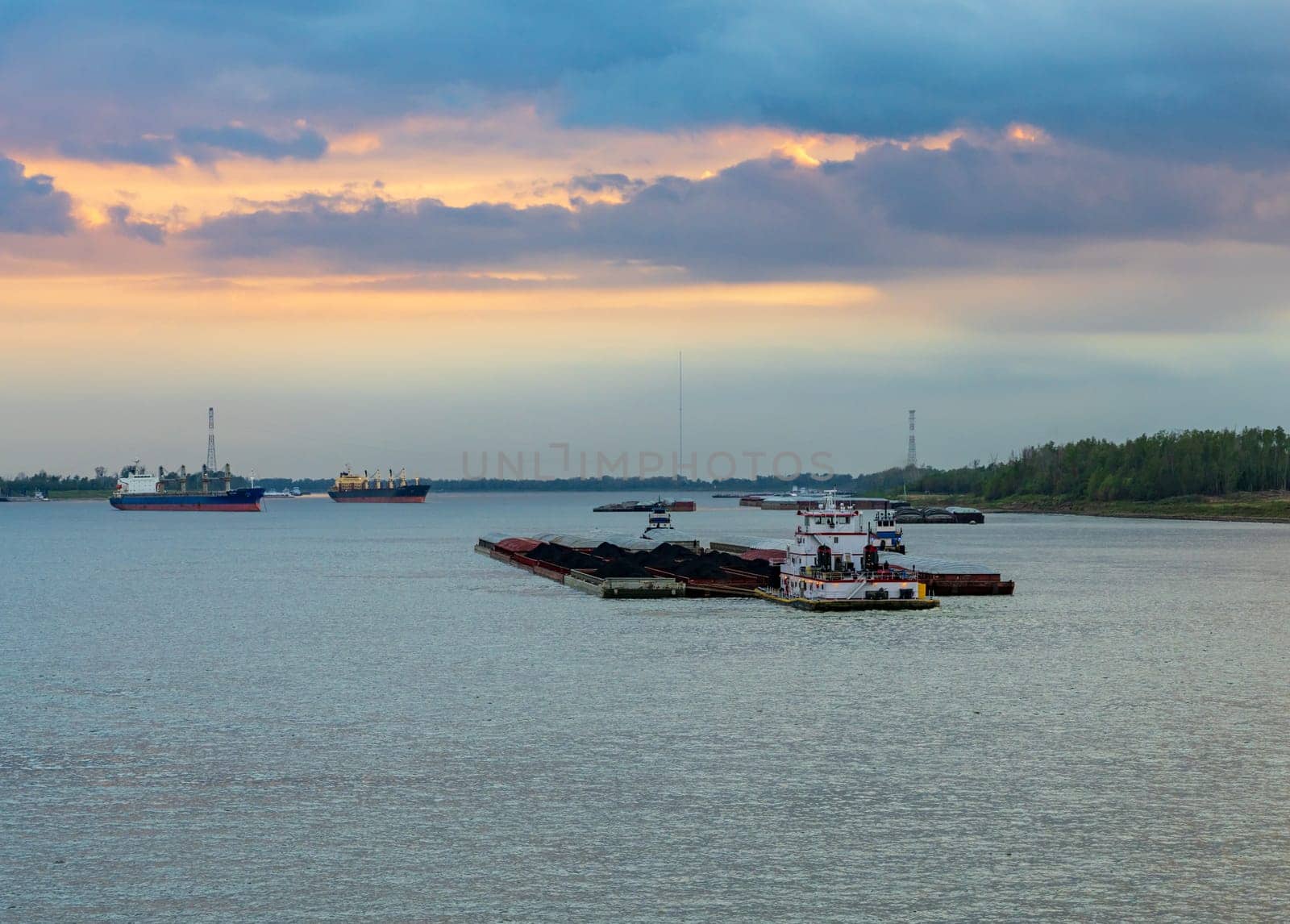 Sunset over the coal barge in Baton Rouge, Louisiana by steheap
