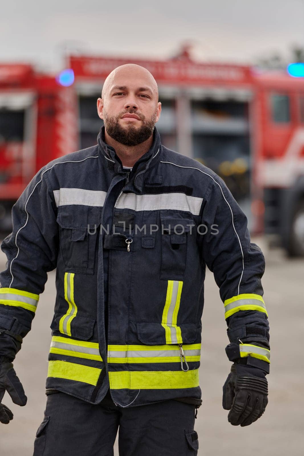 A symbolically brave firefighter strides forward with unwavering courage, epitomizing dedication and leadership, while behind him, a modern firetruck stands ready for firefighting actions, capturing the essence of heroism and preparedness in the face of emergency by dotshock