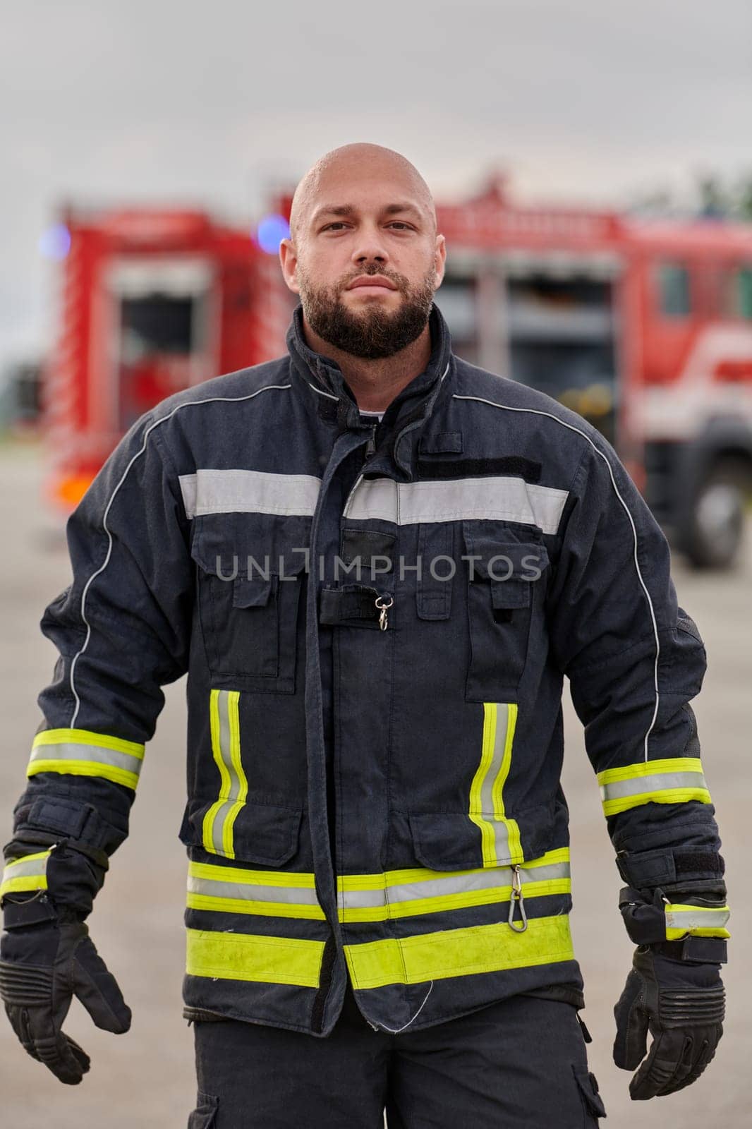 A symbolically brave firefighter strides forward with unwavering courage, epitomizing dedication and leadership, while behind him, a modern firetruck stands ready for firefighting actions, capturing the essence of heroism and preparedness in the face of emergency.