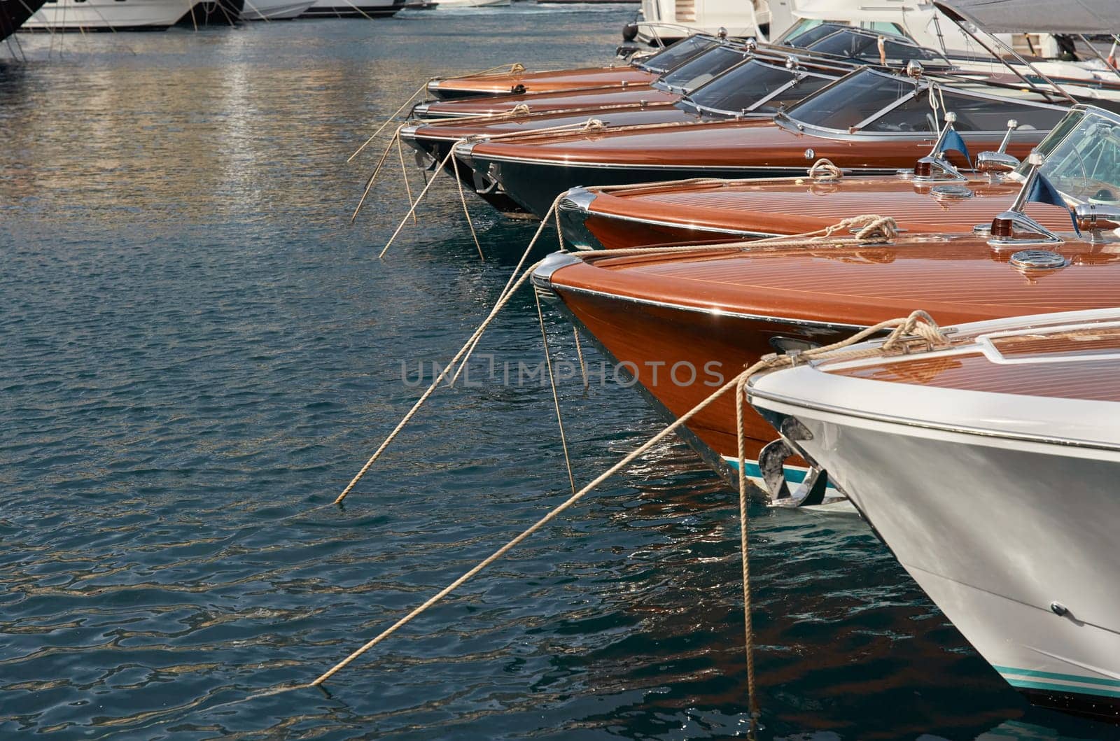 Few luxury retro motor boats in row at the famous motorboat exhibition in the principality of Monaco, Monte Carlo, the most expensive boats for the richest people, boats for rich clients