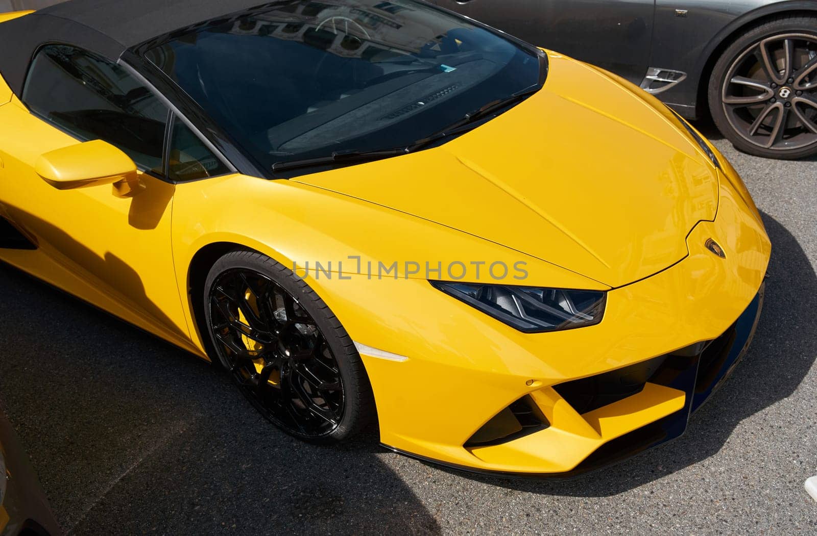 Monaco, Monte Carlo, 29 September 2022 - Close-up view of yellow sports car Lamborghini on street by vladimirdrozdin