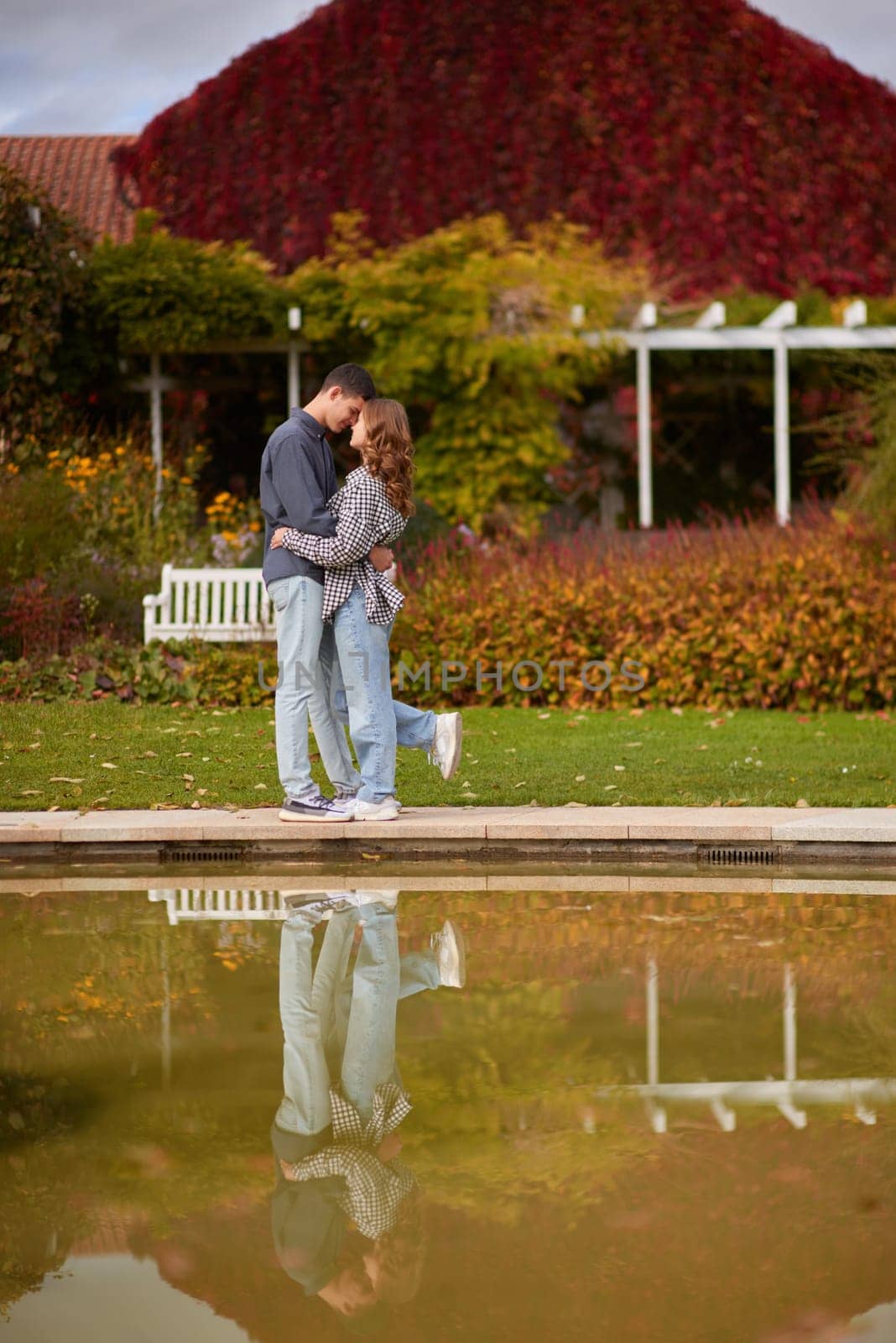 lovely young couple kissing outdoors in autumn. Loving couple walking in nature. Autumn mood. Happy man and woman hugging and kissing in autumn. Love. Fashionable couple outdoors. Fashion, people and lifestyle. Stylish couple in autumn outfit.