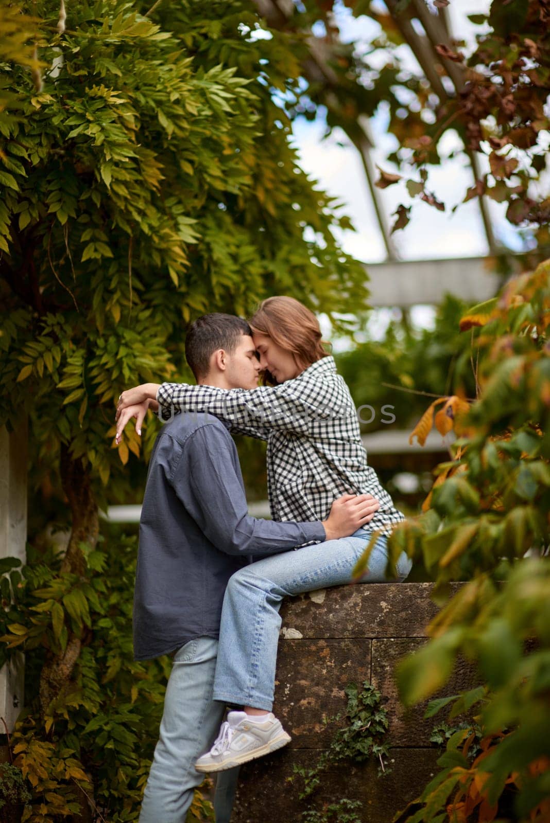 Young Cute Female Hugs Boyfriend. In Autumn Outdoor. Lovers Walking in Park. Attractive Funny Couple. Lovestory in Forest. Man and Woman. Cute Lovers in the Park. Family Concept. Happy Couple.