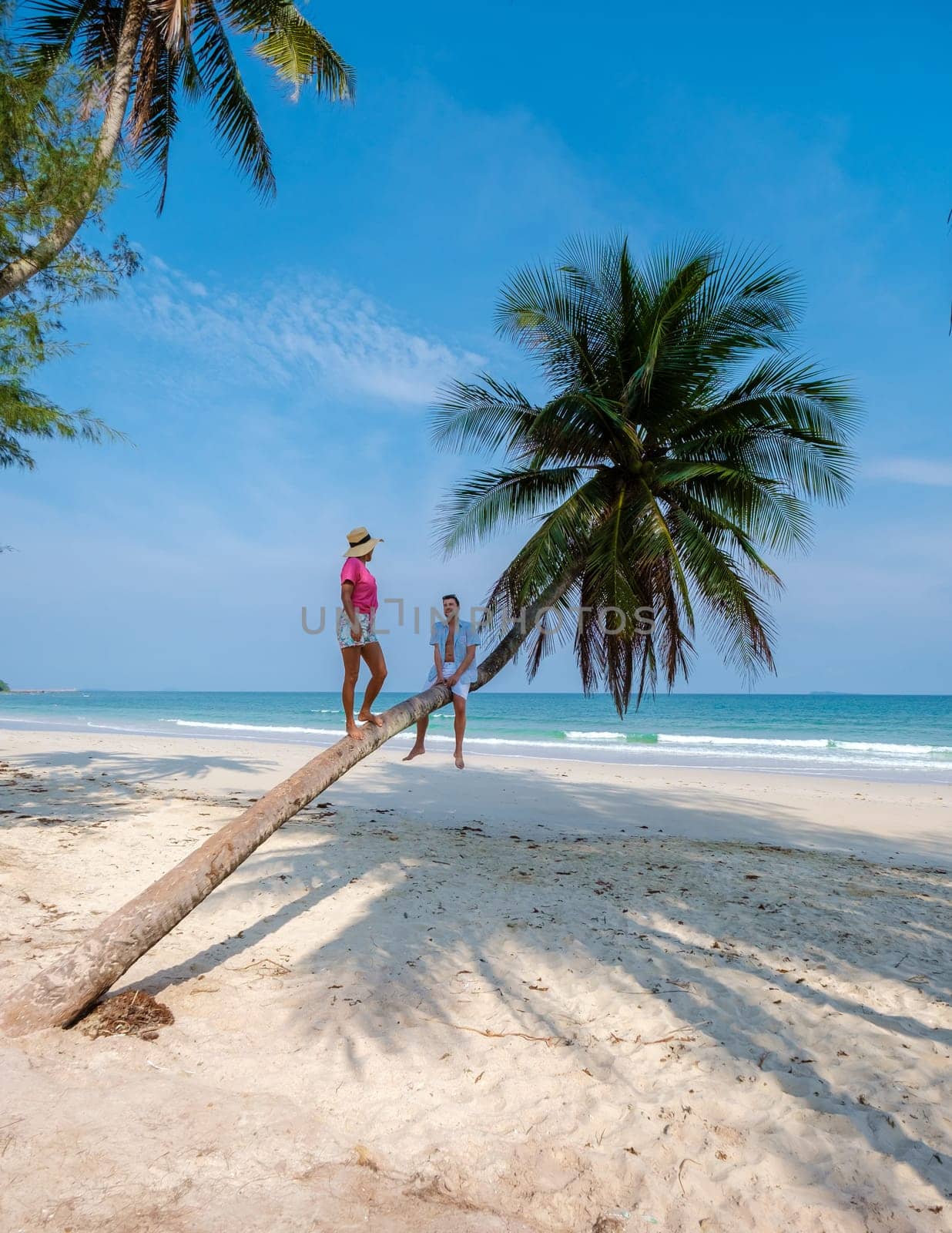 couple on vacation in Thailand, Chumpon province, white tropical beach with palm trees by fokkebok