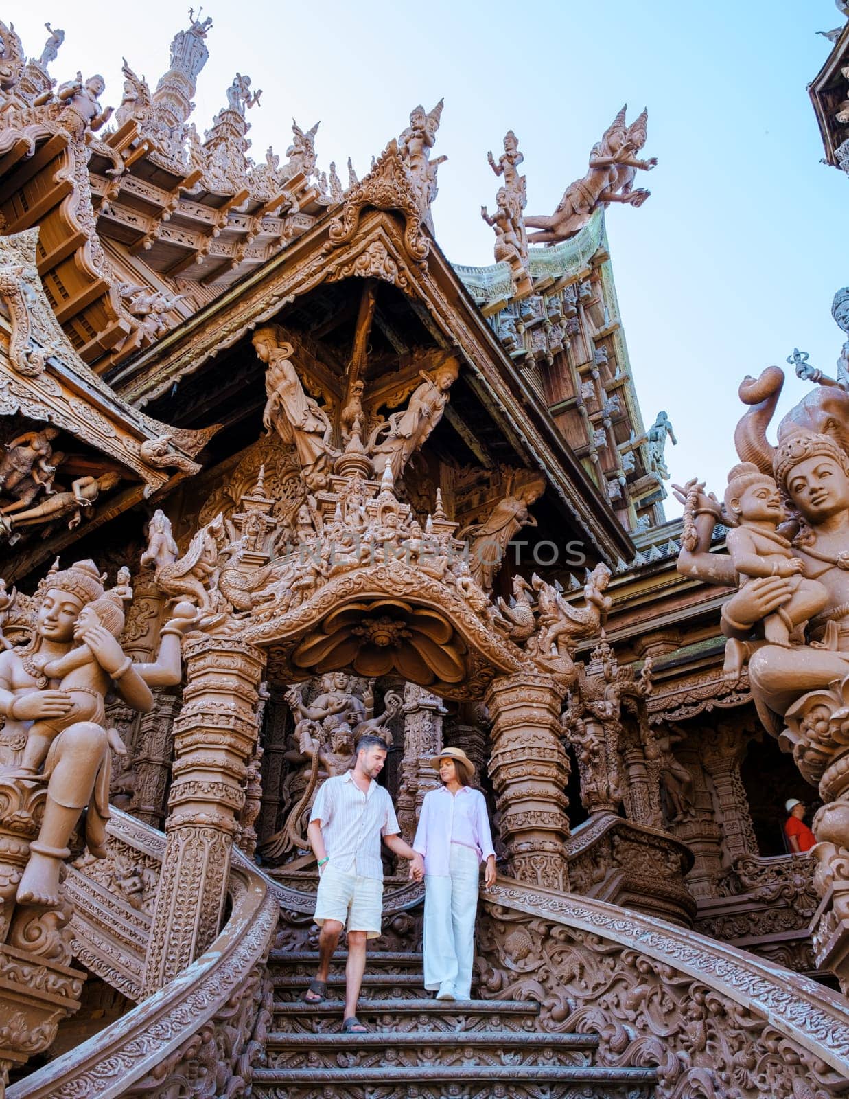 A couple visit The Sanctuary of Truth wooden temple in Pattaya Thailand by fokkebok