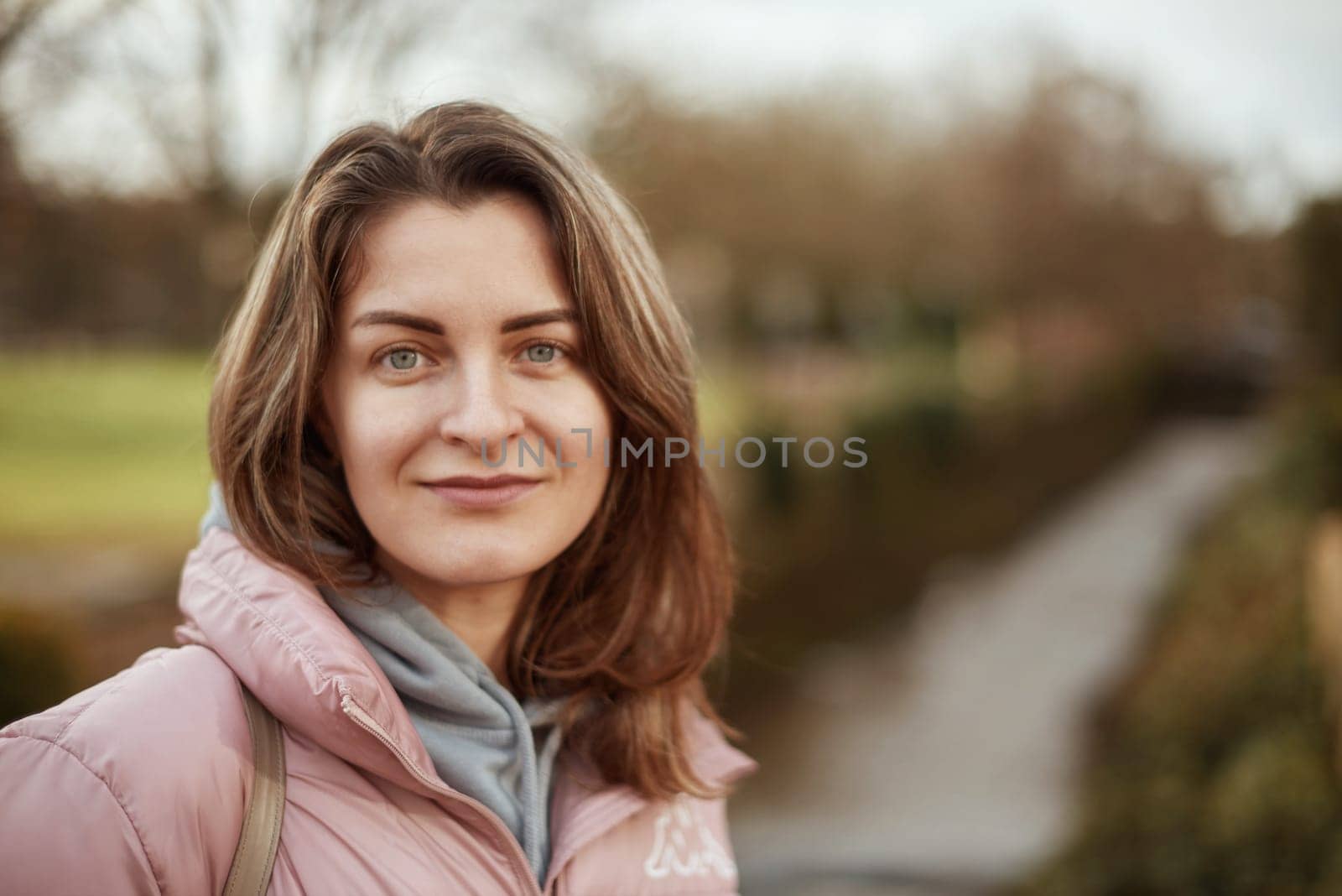 Young beautiful pretty tourist girl in warm hat and coat with backpack walking at cold autumn in Europe city enjoying her travel in Bietigheim-Bissingen, Deutschland. Outdoor portrait of young tourist woman enjoying sightseeing by Andrii_Ko