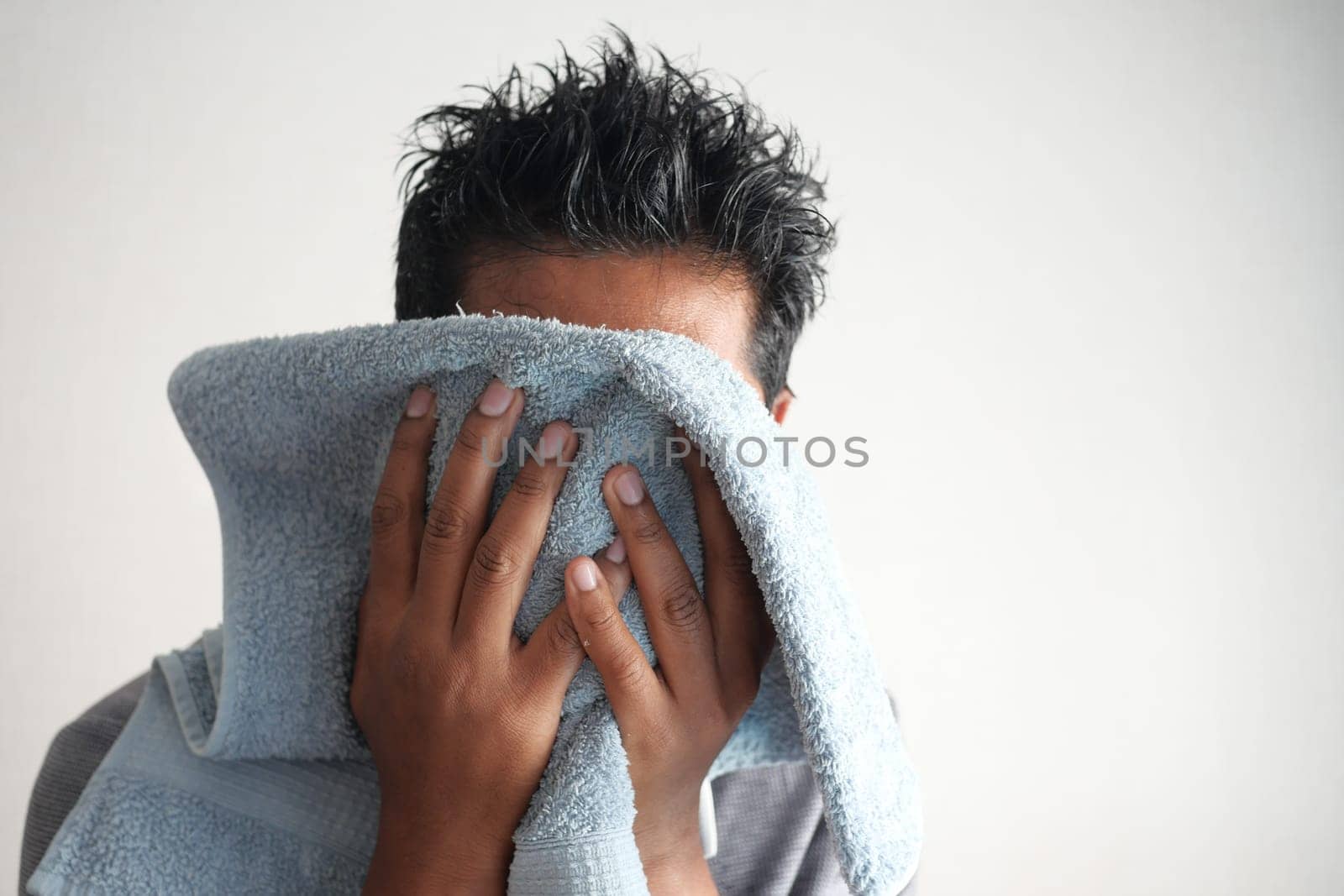 young Man drying his face