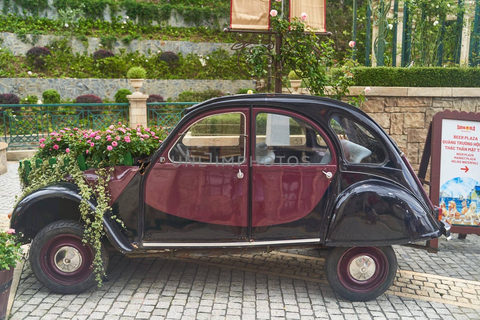 Vintage car decorated with flowers in the photo zone in a romantic style by driver-s