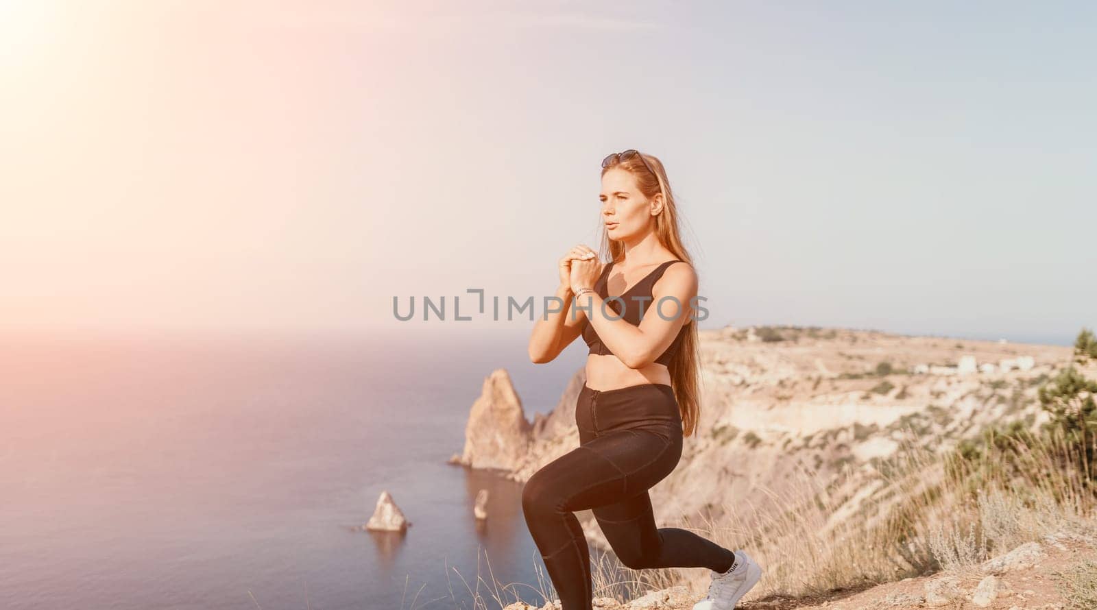 Fitness woman sea. Outdoor workout with fitness rubber bands in park over beach. Female fitness pilates yoga routine concept. Healthy lifestyle. Happy fit woman exercising with rubber band in park