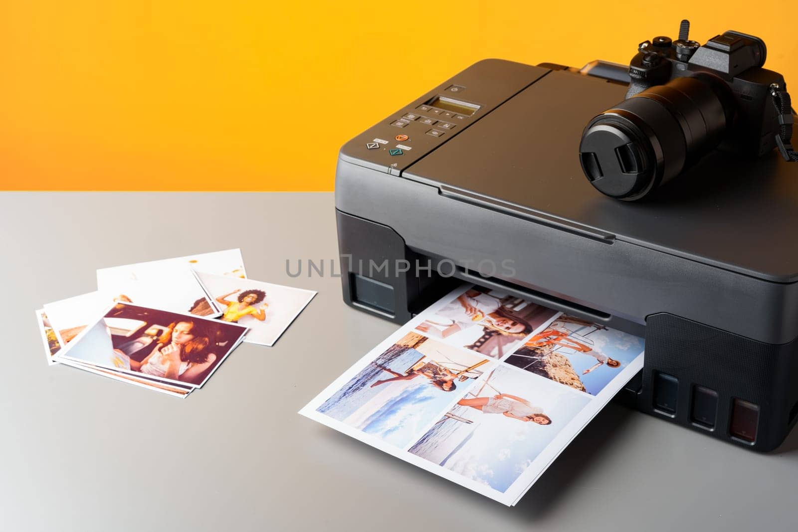 Printer printing colorful photos of people close up, yellow background, studio shot