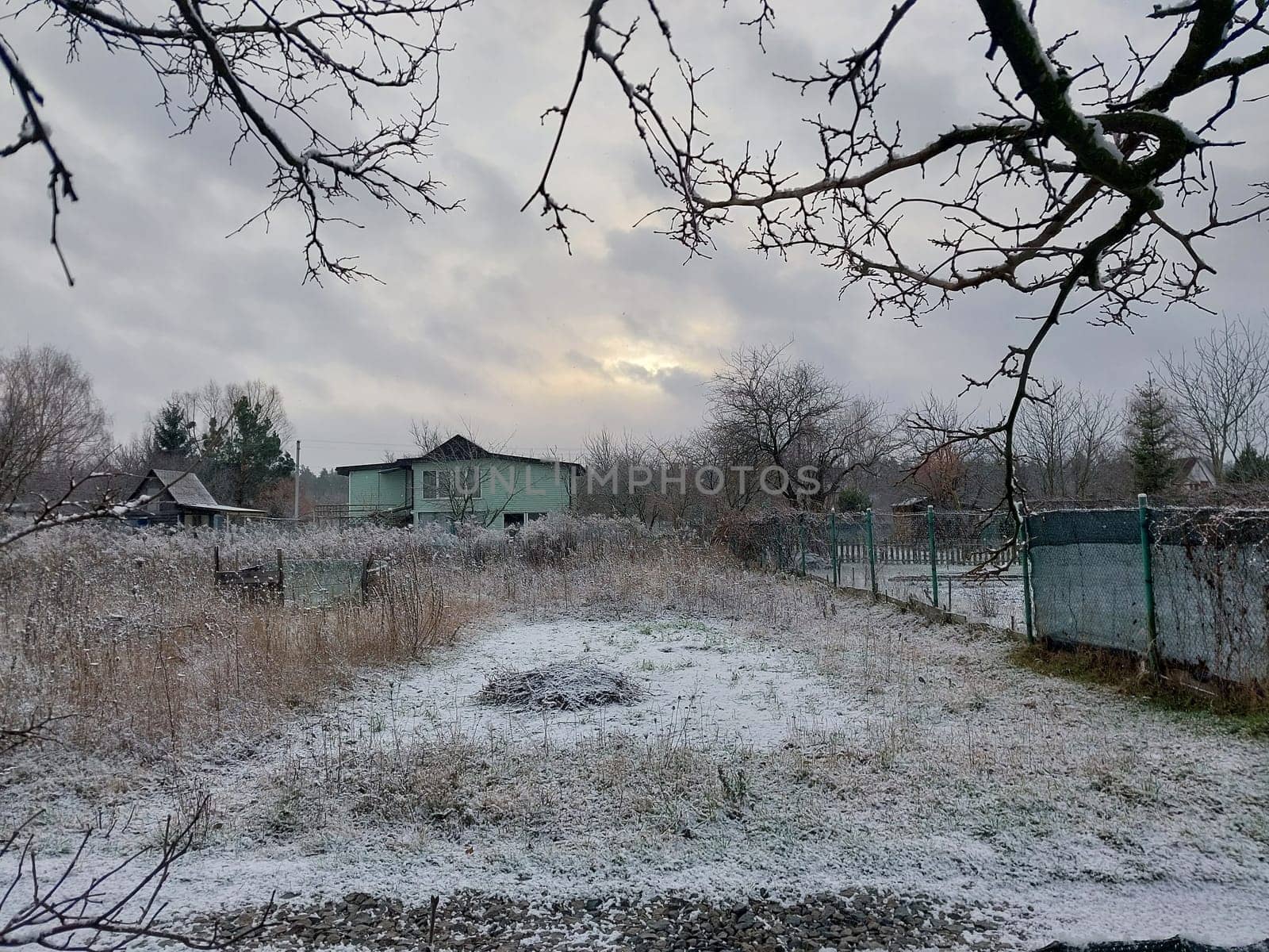 Snow fell on the garden where vegetables grow in the village by architectphd