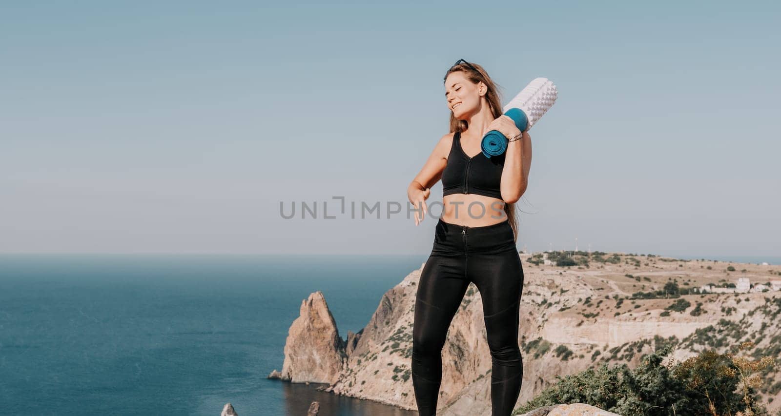 Fitness woman sea. Outdoor workout with fitness rubber bands in park over beach. Female fitness pilates yoga routine concept. Healthy lifestyle. Happy fit woman exercising with rubber band in park. by panophotograph