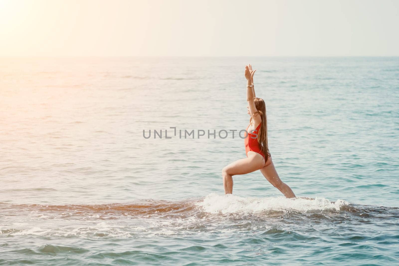 Woman sea yoga. Back view of free calm happy satisfied woman with long hair standing on top rock with yoga position against of sky by the sea. Healthy lifestyle outdoors in nature, fitness concept.