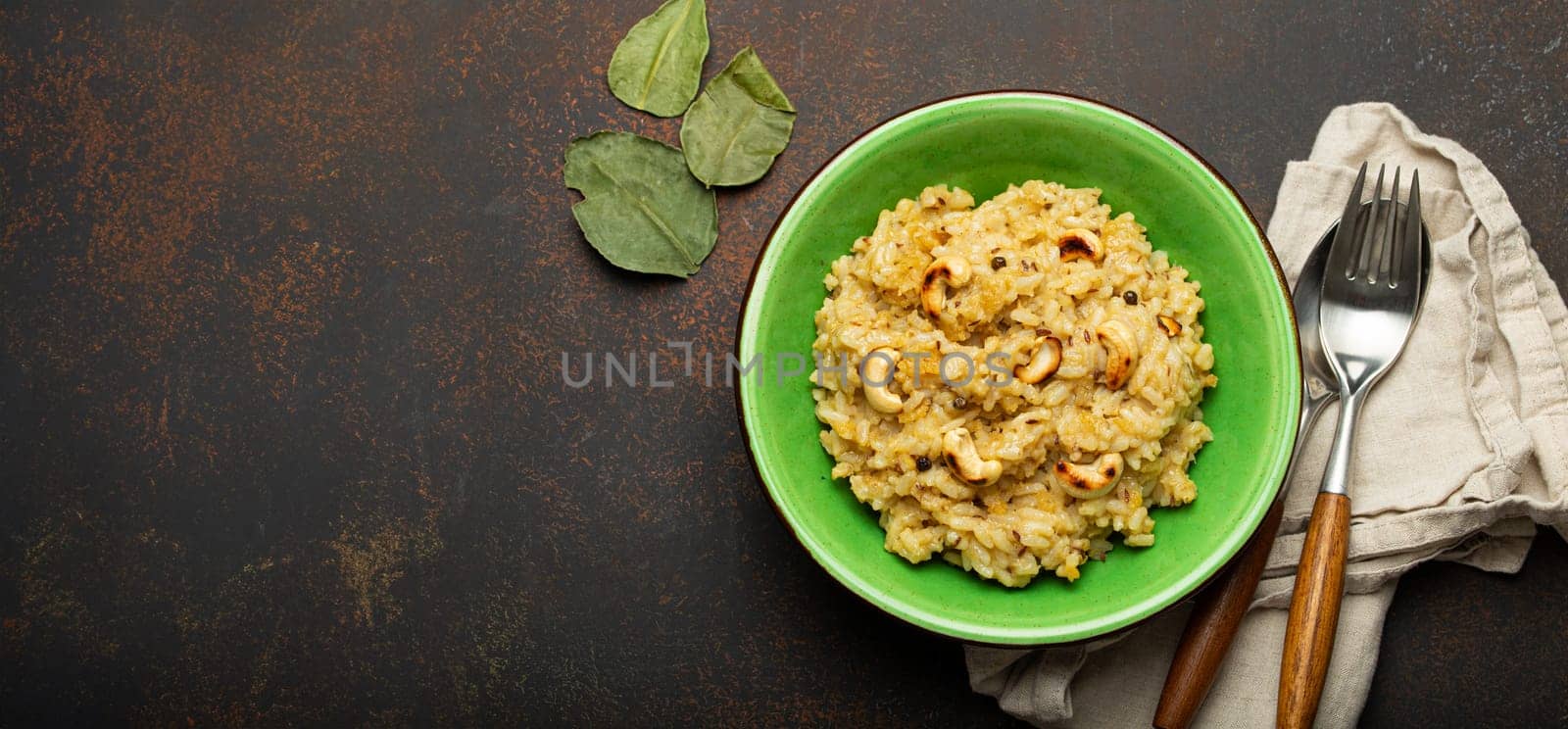 Ven Pongal (Khara Pongal), traditional Indian savoury rice dish made during celebrating Pongal festival, served in bowl top view on concrete rustic background, space for text.